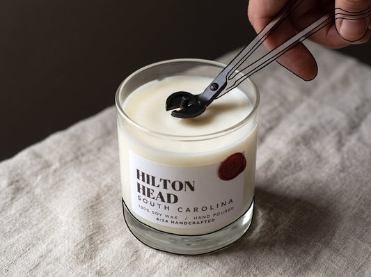 Wick being trimmed before a candle burn for proper candle care