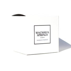 The Magnolia Springs, Alabama candle box with a Magnolia and Teakwood scent label