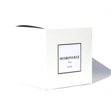 White candle box with a simple modern box logo on the front